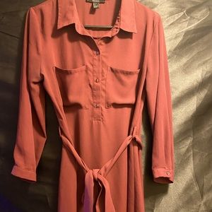 Red dress with button up and tie in the mid.
